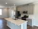 Open-concept kitchen with stainless steel appliances, quartz countertops, and hardwood flooring at 3007 Honeymyrtle Ln, Durham, NC 27703