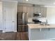 Modern kitchen with stainless steel appliances, subway tile backsplash, island, and shaker style cabinets at 3007 Honeymyrtle Ln, Durham, NC 27703