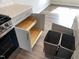 Kitchen cabinets with built-in organizers and trash can storage, accented by quartz countertops at 3007 Honeymyrtle Ln, Durham, NC 27703