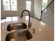 Modern kitchen island featuring a stainless steel sink and elegant countertops at 3007 Honeymyrtle Ln, Durham, NC 27703