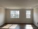 Bright living room with hardwood flooring and windows offering natural light at 3007 Honeymyrtle Ln, Durham, NC 27703