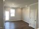 Cozy living room with recessed lighting, wood floors and door to outdoor patio at 3007 Honeymyrtle Ln, Durham, NC 27703