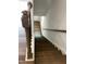 View looking down staircase featuring wood treads and black metal spindles at 3007 Honeymyrtle Ln, Durham, NC 27703