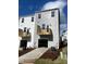 New townhome with a balcony above the garage and siding in shades of white and gray at 3012 Honeymyrtle Ln, Durham, NC 27703