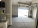 Spacious garage with an overhead door, concrete floors, and visible mechanical systems at 3012 Honeymyrtle Ln, Durham, NC 27703