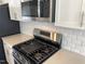Modern kitchen featuring stainless steel appliances, white cabinets and subway tile backsplash at 3012 Honeymyrtle Ln, Durham, NC 27703