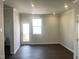 Bright living room featuring new flooring, trim, and an exterior door with windows at 3012 Honeymyrtle Ln, Durham, NC 27703