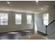 Bright open-concept living area with recessed lighting, dark hardwood floors, and multiple windows allowing natural light at 3012 Honeymyrtle Ln, Durham, NC 27703