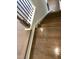 Hardwood staircase descends to new flooring and a white trim for a stylish transition at 3012 Honeymyrtle Ln, Durham, NC 27703