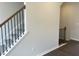 Second story landing with staircase, white walls, and dark floors, creating a bright and welcoming atmosphere at 3012 Honeymyrtle Ln, Durham, NC 27703