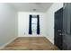 Empty bedroom with natural light, hardwood style flooring and a dark door at 3031 Winston Dr # Apt 302, Burlington, NC 27215