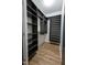 Walk-in closet offering plenty of storage with built-in shelving and hardwood style flooring at 3031 Winston Dr # Apt 302, Burlington, NC 27215