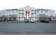 Apartment building featuring balconies, complementary parking and well-maintained landscaping with flowering trees at 3031 Winston Dr # Apt 302, Burlington, NC 27215