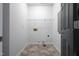 Bright laundry room features wire shelving and durable flooring, with a hookup for a dryer at 3031 Winston Dr # Apt 302, Burlington, NC 27215