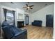 Spacious living room featuring hardwood style floors, a fireplace and modern ceiling fan at 3031 Winston Dr # Apt 302, Burlington, NC 27215
