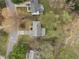 Aerial view of property with spacious backyard, mature trees, and a trampoline at 3416 Cottonwood Dr, Durham, NC 27707