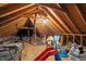 Unfinished attic space showing exposed beams, equipment and ample storage for a variety of items at 3416 Cottonwood Dr, Durham, NC 27707