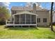 Spacious yard featuring a screened in porch, deck and green grass at 3416 Cottonwood Dr, Durham, NC 27707