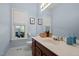 Well-lit bathroom features classic fixtures, a window, and blue wall paint at 3416 Cottonwood Dr, Durham, NC 27707