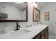 Bathroom boasts dual sinks with black faucets and framed mirrors above the vanity at 3416 Cottonwood Dr, Durham, NC 27707