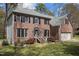 Stately two-story brick home with well-kept lawn and inviting front porch at 3416 Cottonwood Dr, Durham, NC 27707