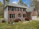 Beautiful two-story red brick home with black shutters and an attached garage in a landscaped yard at 3416 Cottonwood Dr, Durham, NC 27707