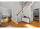 Bright foyer featuring hardwood floors, a staircase, and a glimpse into the living and dining areas at 3416 Cottonwood Dr, Durham, NC 27707
