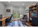 Spacious home office with a large window, built-in bookshelves, and comfortable seating; ideal for productivity at 3416 Cottonwood Dr, Durham, NC 27707