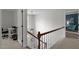 Bright stairway features a pendant light, wood railing, and white trim at 3416 Cottonwood Dr, Durham, NC 27707