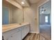 Bathroom featuring double sinks with modern fixtures, white cabinets, and wood-look flooring at 3501 Kensett Way, Raleigh, NC 27616