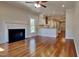 Open-concept living space featuring hardwood floors, a fireplace, and a seamless connection to the kitchen at 3501 Kensett Way, Raleigh, NC 27616