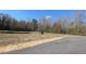 Picture of a residential lot ready to build, surrounded by trees and a clear blue sky at 401 Sweet Potato Lane # 15, Nashville, NC 27856
