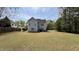 A spacious backyard featuring a well-maintained lawn and a two-story home with a patio and outdoor seating area at 404 Braxman Ln, Holly Springs, NC 27540