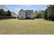 Spacious backyard featuring a well-maintained lawn and a patio area at 404 Braxman Ln, Holly Springs, NC 27540