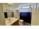 Bathroom with a single sink vanity, and blue shower curtain at 404 Braxman Ln, Holly Springs, NC 27540