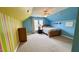 A brightly painted bedroom featuring a bed, dresser, and unique wall decor at 404 Braxman Ln, Holly Springs, NC 27540