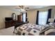 Bedroom featuring a star themed bedspread, ceiling fan and two windows with curtains at 404 Braxman Ln, Holly Springs, NC 27540