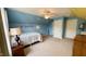 Bright bedroom with bed, ceiling fan, and unique wall decor at 404 Braxman Ln, Holly Springs, NC 27540