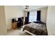 This bedroom features a ceiling fan, a window with blue curtains, and a workspace with computer at 404 Braxman Ln, Holly Springs, NC 27540
