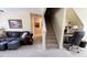 Bonus room provides flexible living with sofa, office space, and staircase access at 404 Braxman Ln, Holly Springs, NC 27540