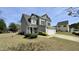 Two story home with a manicured yard and attached two-car garage at 404 Braxman Ln, Holly Springs, NC 27540