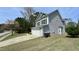 Gray siding house with dormer windows, garage, and a manicured lawn and driveway at 404 Braxman Ln, Holly Springs, NC 27540