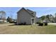 Side view of a home with gray siding, and a well-kept lawn, plus an inviting front porch at 404 Braxman Ln, Holly Springs, NC 27540