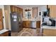 Spacious kitchen with wood cabinetry, stainless appliances, and granite countertops at 404 Braxman Ln, Holly Springs, NC 27540