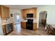 Bright kitchen featuring updated appliances, granite countertops, and wood-look floors at 404 Braxman Ln, Holly Springs, NC 27540