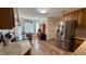 Bright kitchen featuring stainless steel appliances, granite countertops, and wood-look floors at 404 Braxman Ln, Holly Springs, NC 27540