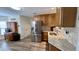 Bright kitchen featuring stainless steel appliances, granite countertops, and wood-look floors at 404 Braxman Ln, Holly Springs, NC 27540