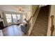 Cozy living room with staircase, fireplace, and large windows at 404 Braxman Ln, Holly Springs, NC 27540