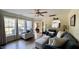 Sunlit living room features large windows, comfortable seating, and seamless open floor plan at 404 Braxman Ln, Holly Springs, NC 27540