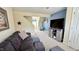 Cozy living room with a comfortable sofa, media center, and neutral decor at 404 Braxman Ln, Holly Springs, NC 27540